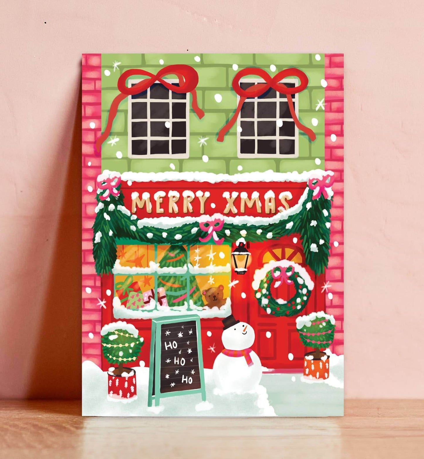 Aniet Illustration - Kerstkaart vrolijke kerst winkel merry Xmas met sneeuwpop - The Dreamer's Bookshop.